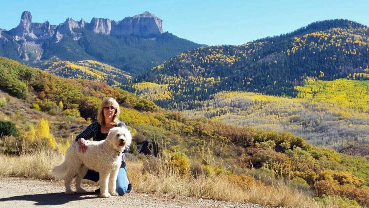 Amby Ronemus is on a stroll with their pooch, Ouray, near the family’s home in Ridgway, Colorado.