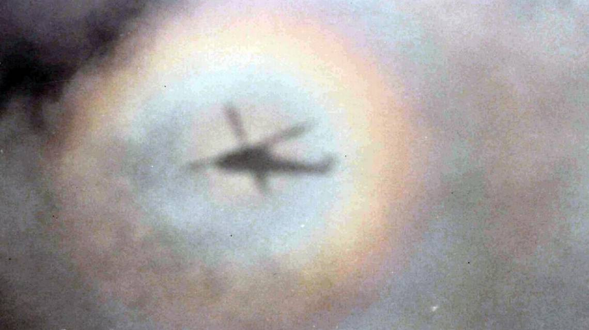A glory surrounds the shadow of a U.S. Navy SH-2F Seasprite helicopter somewhere over the Atlantic Ocean in 1985.