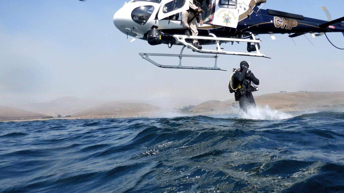 Divers were lowered into the water off the coast of Cayucos to examine an overturned boat, reported on Oct. 24, 2024. 