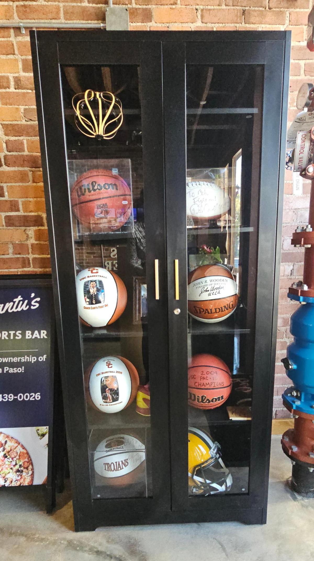 A case displays basketball memorabilia at Bob Cantu’s Pizza and Sports Bar in San Luis Obispo.