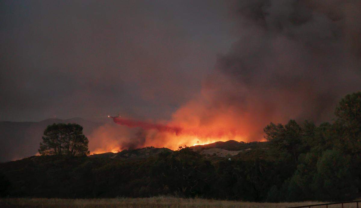 An air tanker drops retardant on the Pond Fire near Santa Margarita on Saturday.