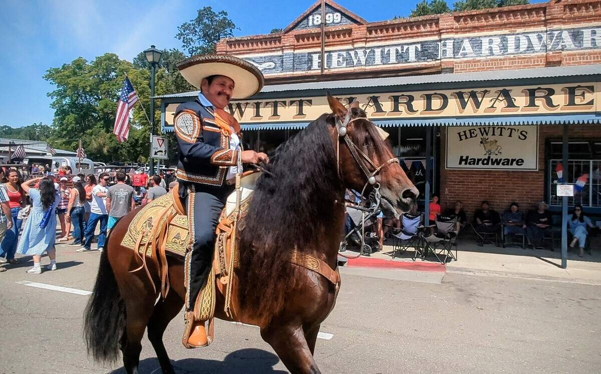 A charro rider carrying an American flag passed Hewitt’s Hardware during Templeton’s annual Fourth of July Parade on Saturday, July 4, 2026.
