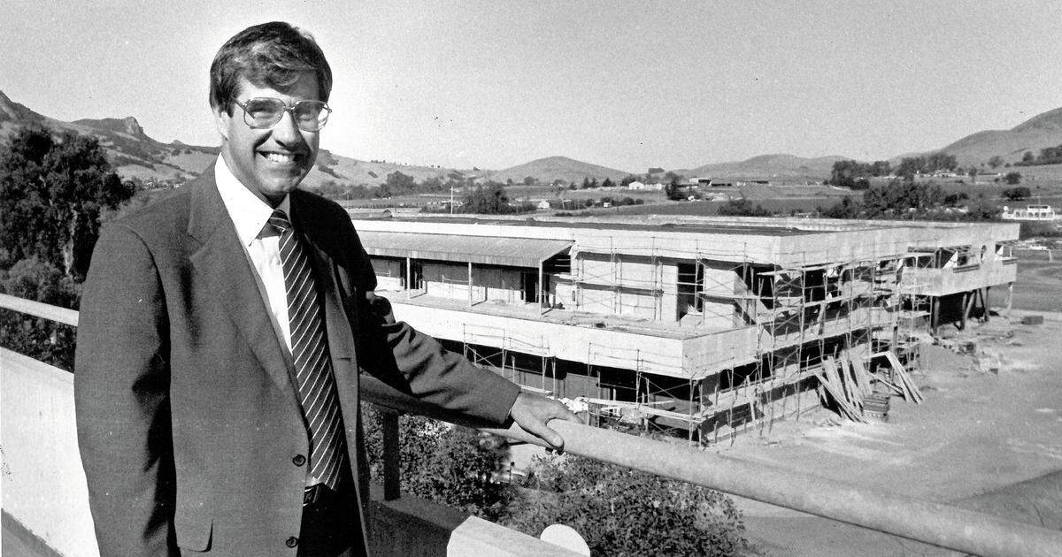 Cal Poly President Warren Baker in a photo from the 1980s overlooking a new building under construction on campus.