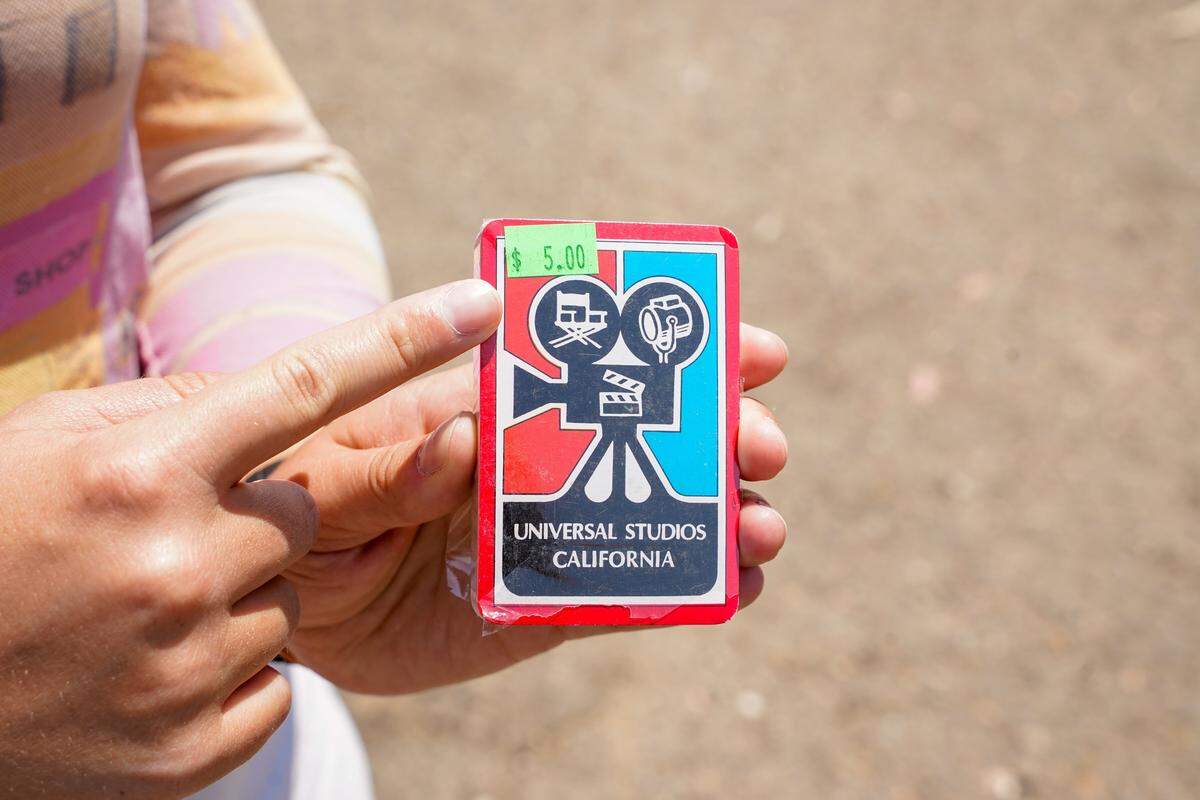 Tribune reporter Hannah Poukish holds a deck of old playing cards that she haggled from $5 down to $3 at the Nipomo Swap Meet on Sunday, Aug. 10, 2025. The Swap Meet features more than 300 vendors, the largest market of its kind on the Central Coast.