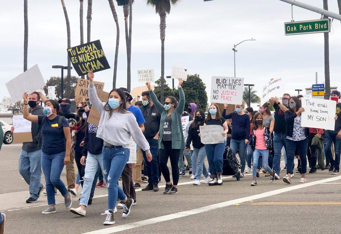 Protesters march in the intersection of Oak Park Boulevard and Grand Avenue in Arroyo Grande during a demonstration on June 5.