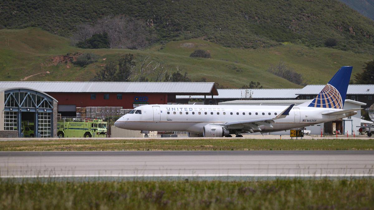 United Express aircraft prepares to depart from San Luis Obispo County Regional Airport, fire engine and station in the background, April 20, 2023.