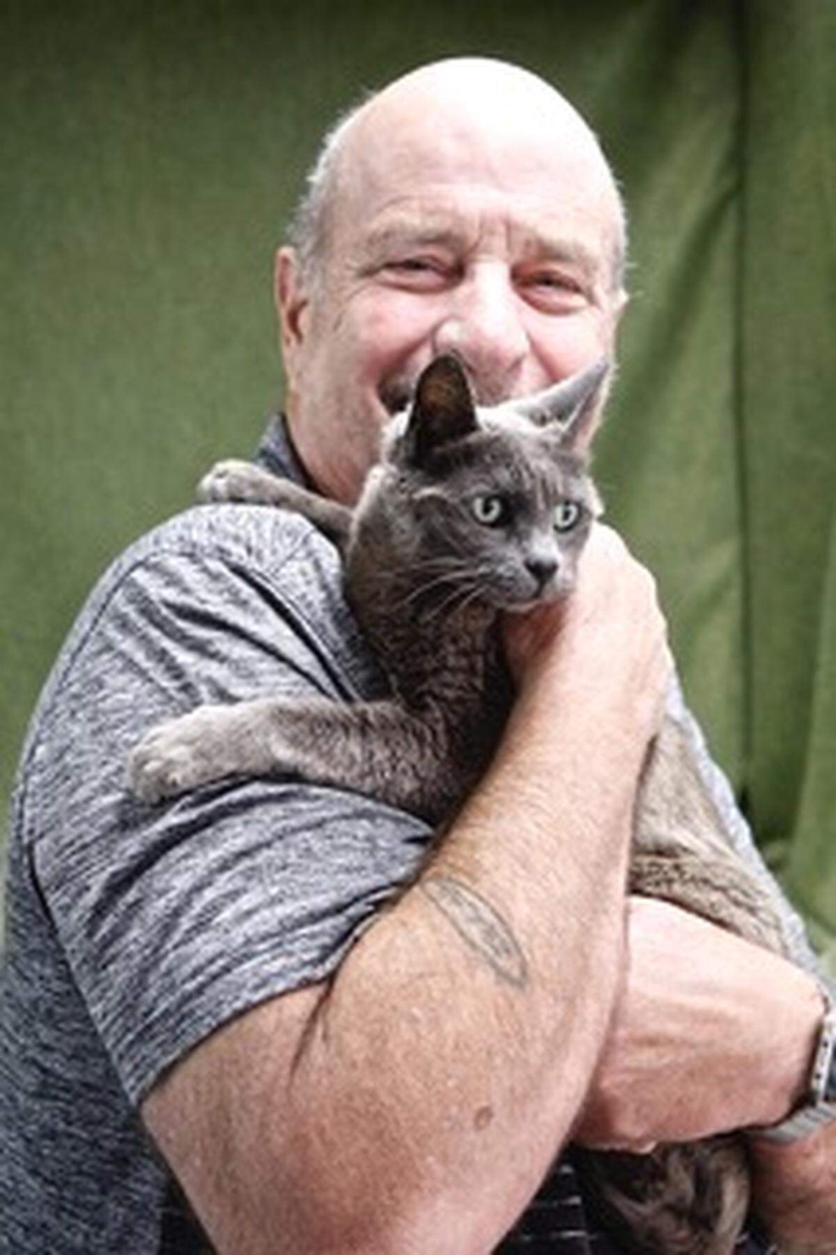 Rick Hutchins of Tucson, Arizona, is reunited with Gracey the cat after the pet was lost at San Simeon State Park campground.