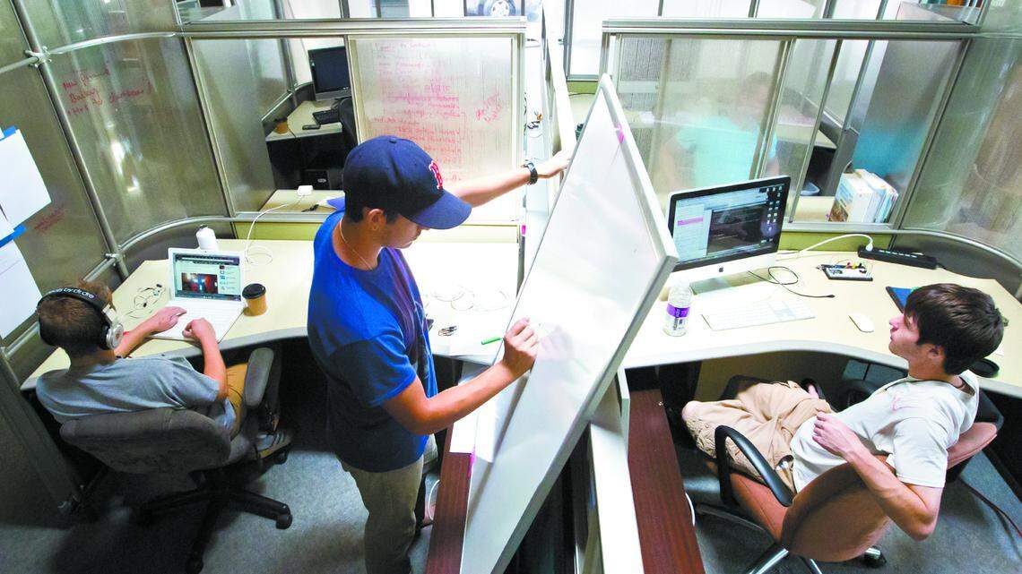 Max Mero and Garrett Milster work on their start-up RapairTech while Tyler Wirght Chase-Nason, from Autonomous Surveyor, occupies the cubicle next to them at SLO Hothouse in 2012. The SLO Hothouse is an incubator for start-up companies launched by Cal Poly students and alumni.