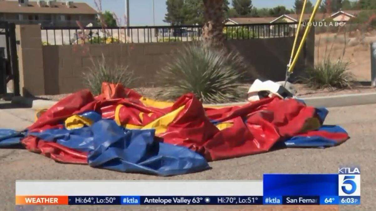A bounce house blew from a residential neighborhood onto a highway in California's High Desert on Saturday, causing a 9-year-old boy who was in the bounce house to receive minor injuries.