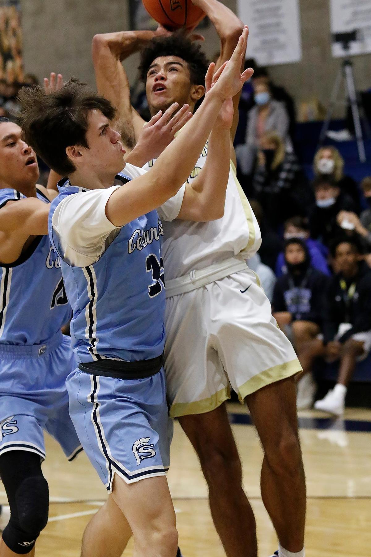 Mission Prep’s J.J. Howard (23) goes for a basket under pressure from Saugus’ players. The Mission Prep Classic basketball tournament gets underway with some of the top teams in the state.
