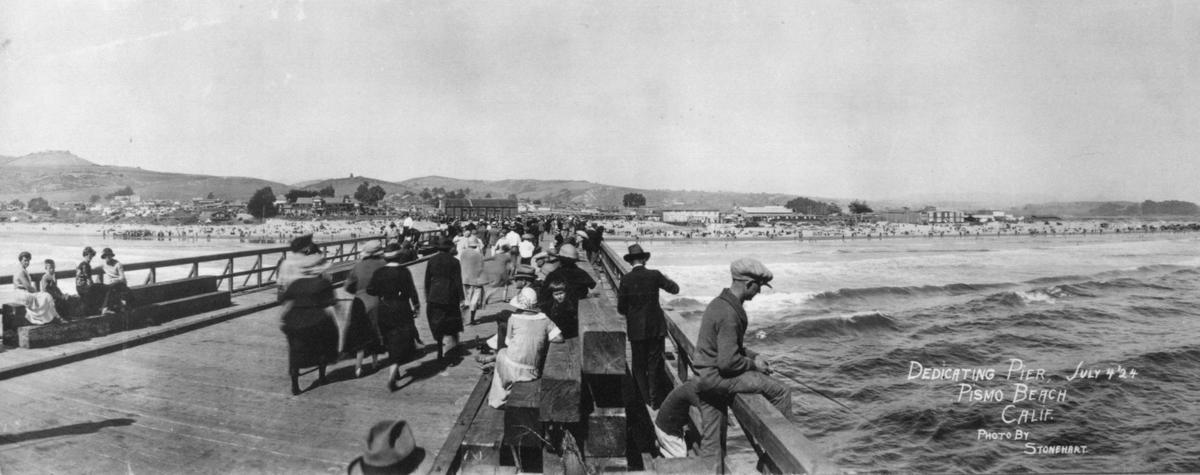 A photo of the Pier in Pismo Beach on opening day July 4, 1924. Women and men wore hats as they strolled on the new $150,000 pier and a men fished off the structure, though this was the era before surfing became popular.
