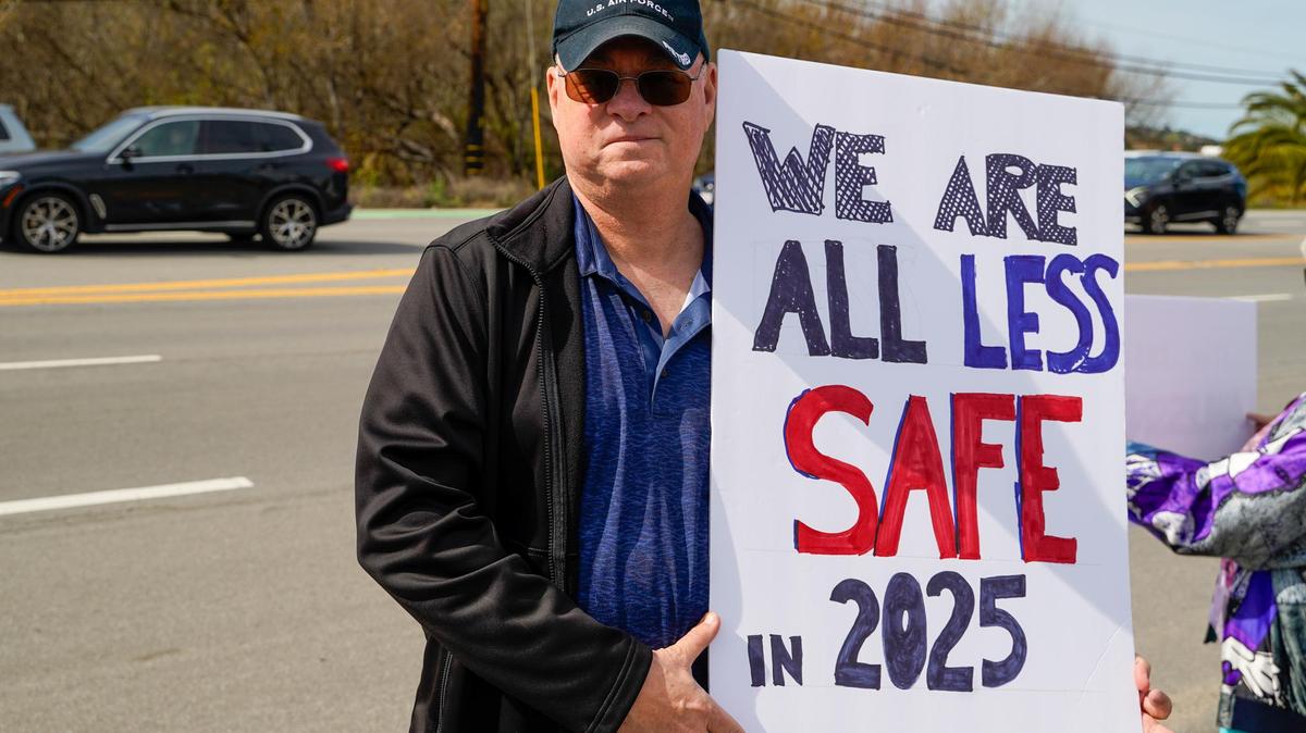 Retired United States Air Force Master Chief Nolan Meeks holds a sign during a protest on Los Osos Valley Road on Monday, Feb. 17, 2025. Meeks said Donald Trump and Elon Musk’s first month in office represent a threat to veterans and programs such as Medicare.