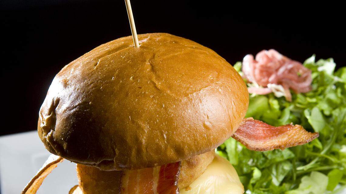 The Willow Burger features stout-braised mushrooms, smoked Gouda, bacon and an onion ring on a brioche roll, with fries or a side salad.