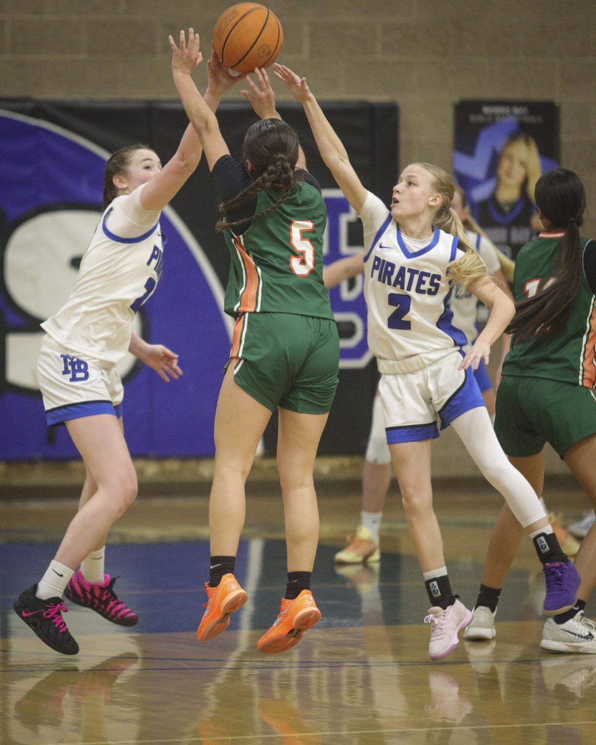 Violet Pace.left and Zoe Fitzwater combine to block a shot by Saré Ortiz in the late minutes. Morro Bay beat Porterville 37-25 to advance to the semi-final game in the Division III CIF Central Section Girls Basketball Championships.