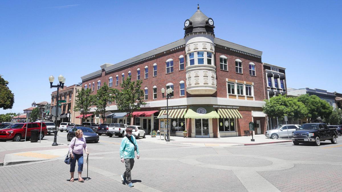 People stroll in downtown Paso Robles, near the Acorn Building is at the corner of 12th and Park streets