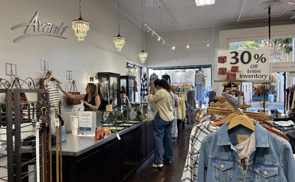 Avanti owner Kristen Walker helps a customer check out on Friday, Sept. 5, 2025. The longtime women’s clothing store in downtown San Luis Obispo announced that it was closing after more than 30 years.