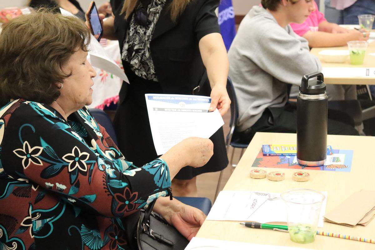 An attendee at the LatinX Voter Empowerment Workshop at the Nipomo library on Sept. 11, 2024, receives Spanish resources on registering and voting. Two events have been held so far in Atascadero and Nipomo, and four more are planned over the coming weeks in San Miguel, Cambria, Oceano and San Luis Obispo.