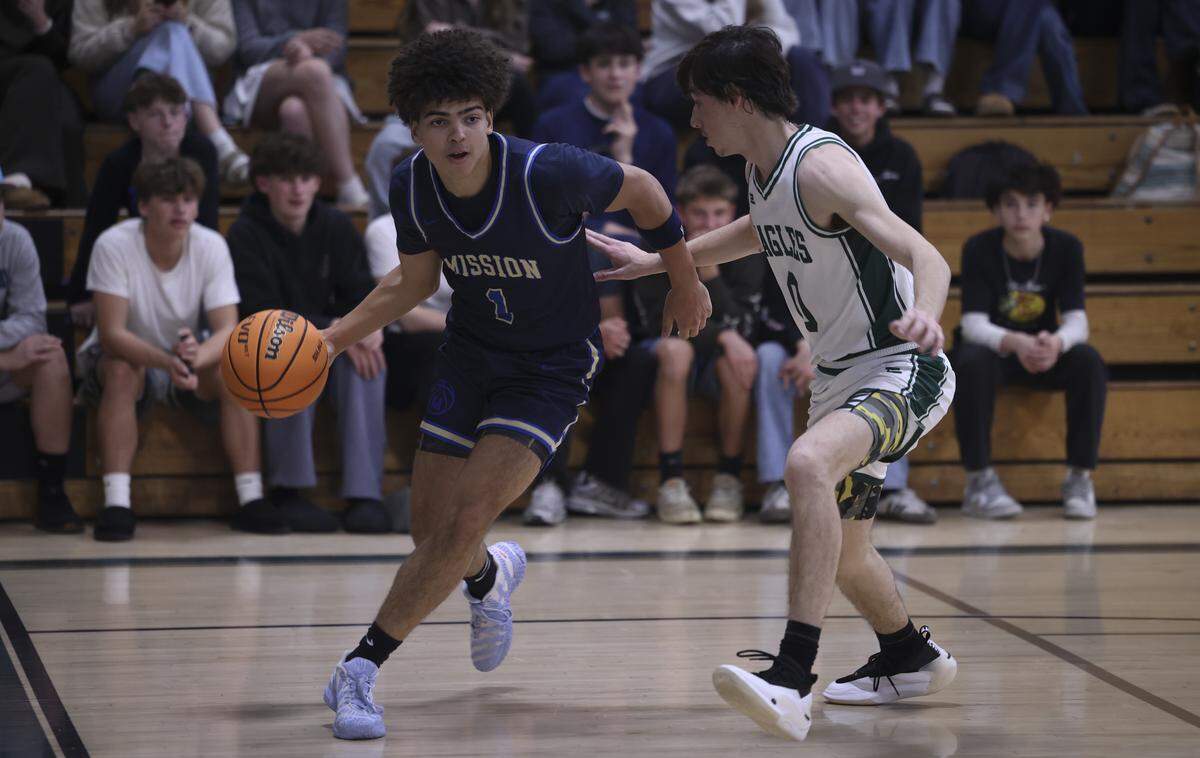 Hunter Drake works toward the basket defended by Ethan Tonini. Templeton beat Mission Prep in overtime, 76-70 on Jan. 7, 2026.