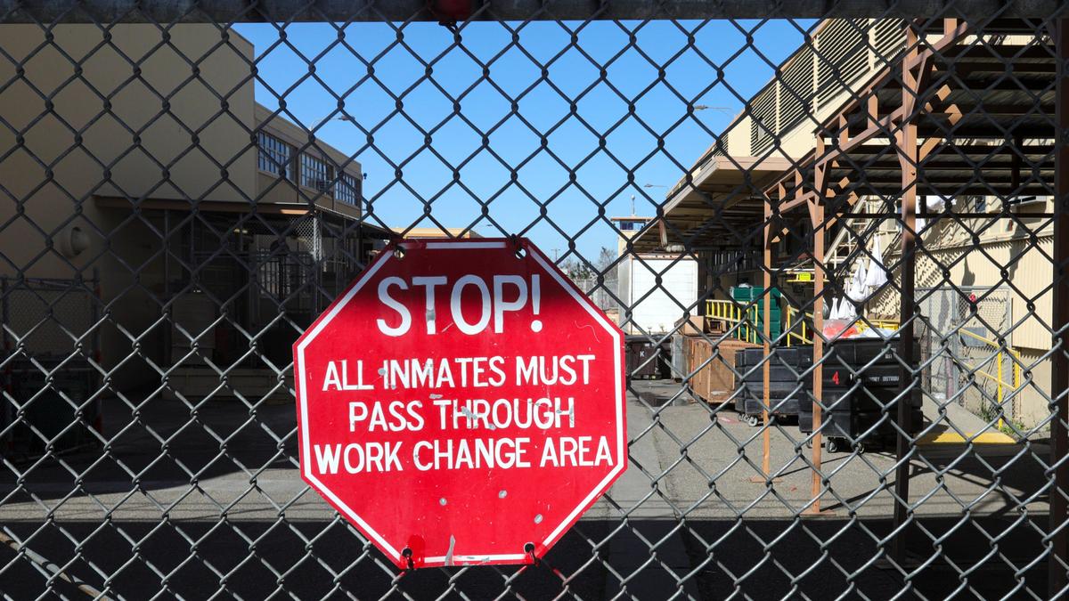 A gate blocks an exit at the California Men’s Colony’s East facility. The facility’s laundry is located to right.