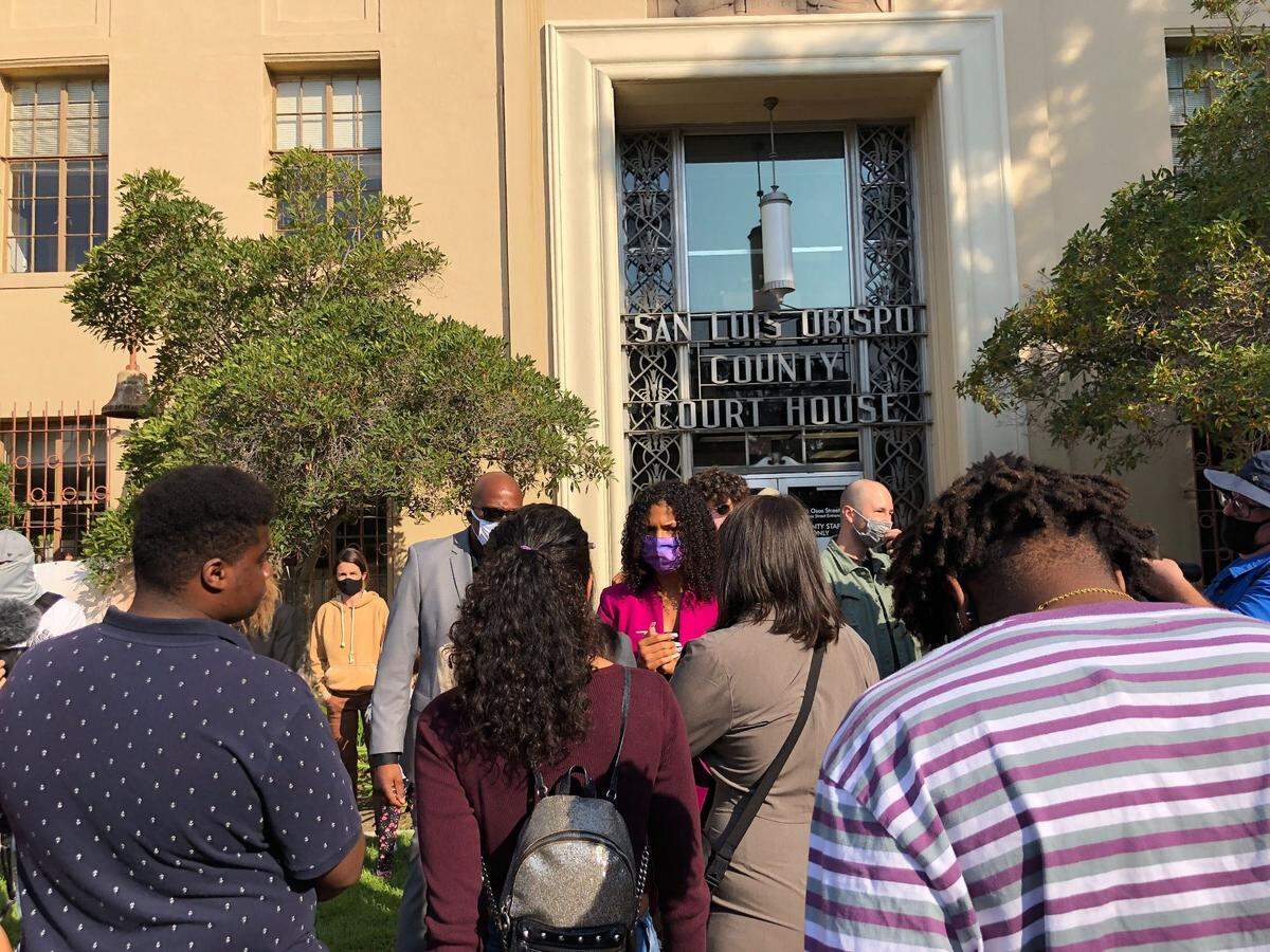 Black Lives Matter activist Tianna Arata, center in purple face mask, speaks to supporters outside the San Luis Obispo County courthouse on Thursday, Sept. 3, 2020.