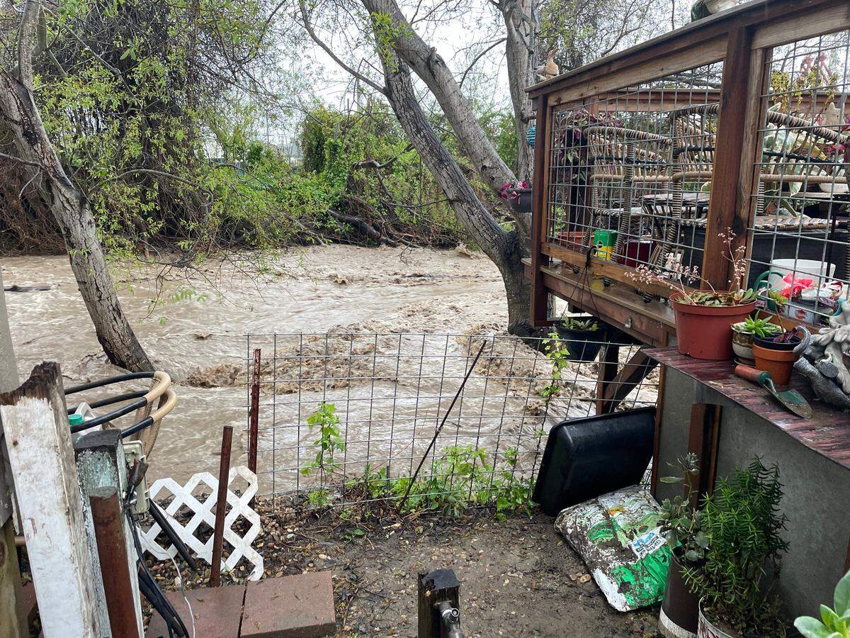 The Morro Creek overflows into residents’ back yards of the Silver City west mobile home village in Morro Bay. Residents next to the creek were ordered to evacuate as the creek overflowed on March 10.