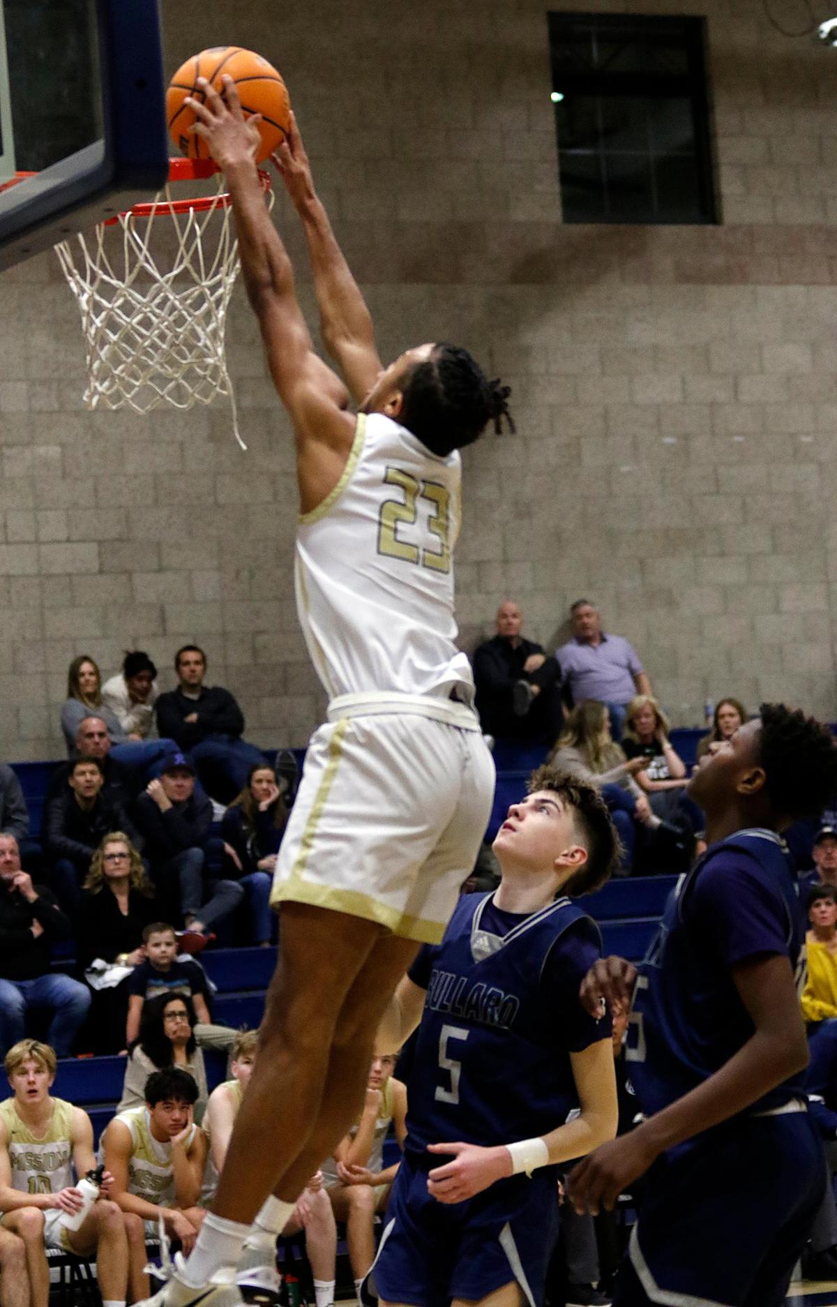 Mission Prep’s Jamar Howard (23) dunks the basketball. The Mission Prep boys basketball team beat Bullard High School 66-50 in a first-round playoff game in San Luis Obispo, Feb. 15, 2023.