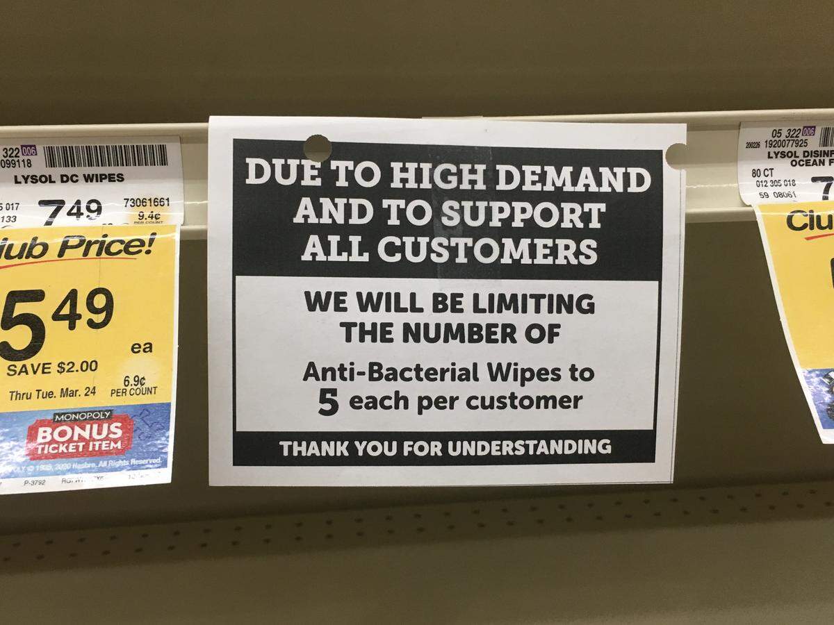 A sign on a shelf at Vons in San Luis Obispo notes that the grocery store is limiting sales of packages of anti-bacterial wipes to five per customer.
