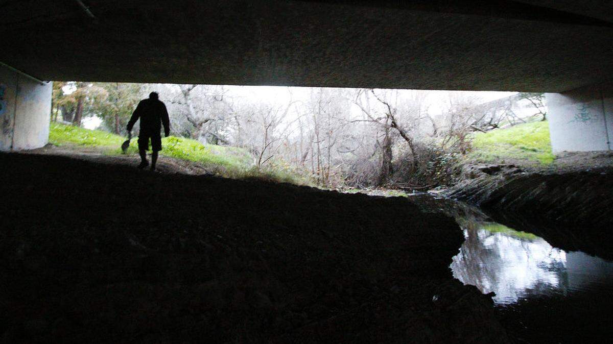 Carey Vasquez looks under a bridge for signs of camping in Atascadero on Monday, Jan. 26, 2015, during a biennial countywide survey.