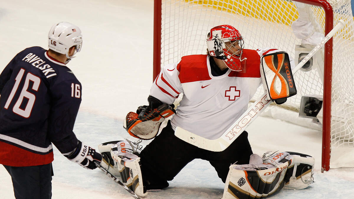 Switzerland's Jonas Hiller (1) blocks a shot by USA's Joe Pavelski (16). (Harry E. Walker/MCT)