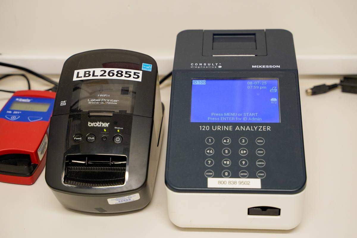 Lab equipment used for analyzing urine samples and printing labels sit in the lab of the Community Health Centers' 40 Prado Homeless Services Center clinic on Thursday, Aug. 7, 2025. CHC provides urgent and primary care to homeless clients of 40 Prado Homeless Services Center.