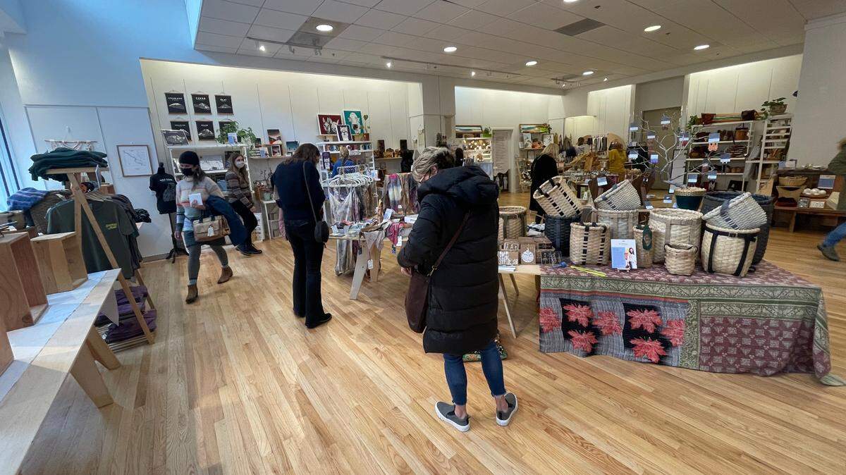 Shoppers look over the selection of gift items at the SLOcally Made store in San Luis Obispo.