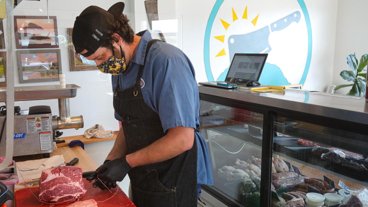 Geoff Montgomery packages a chuck roast at the Morro Bay Meat Market & Deli he and two other partners opened in Morro Bay.
