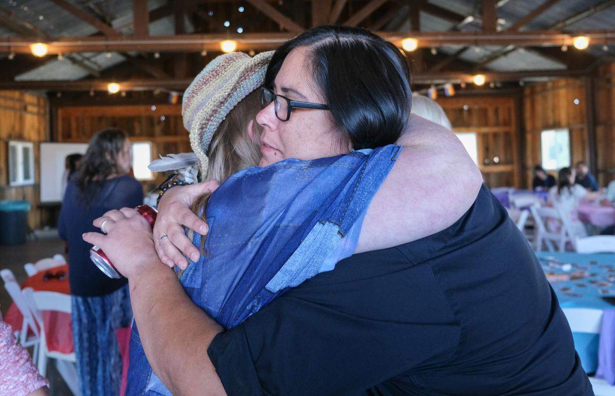 Brandi Anderson hugs a loved one at Todd Pinion’s memorial in Santa Margarita on Nov. 9, 2024. Pinion was killed in an alleged hate crime on Oct. 23, 2024.