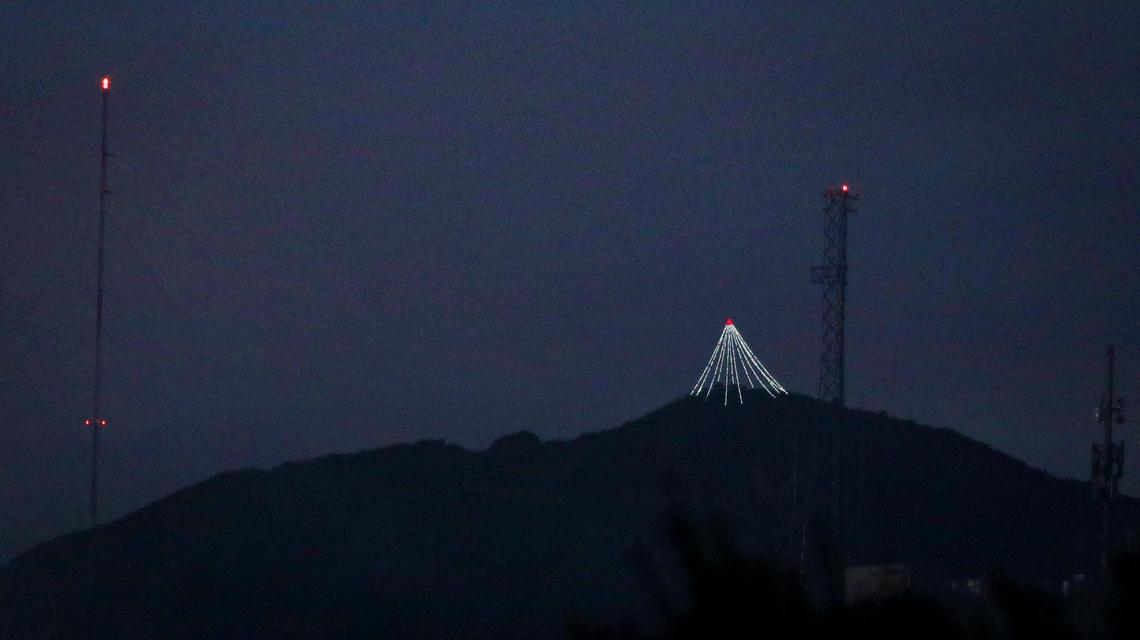 The lighed Christmas Tree atop Cerro San Luis is framed by the cell towers on top of the South Street Hill in San Luis Obispo seen here on Dec. 3, 2023. The tree is a tradition that the Madonna family has carried on since the 1980s.