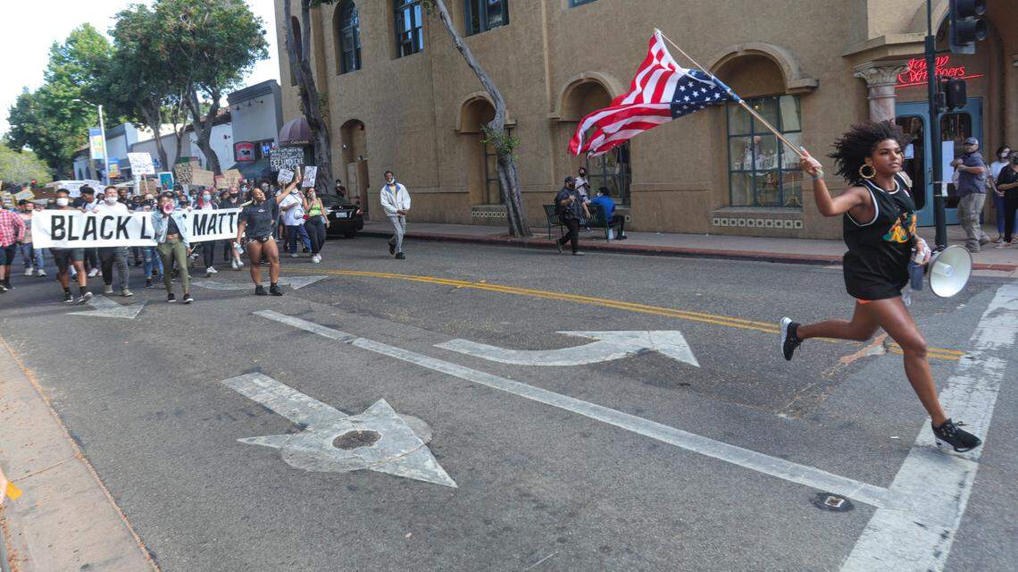 Tianna Arata leads marchers down Chorro Street during the July 21 protest in San Luis Obispo.