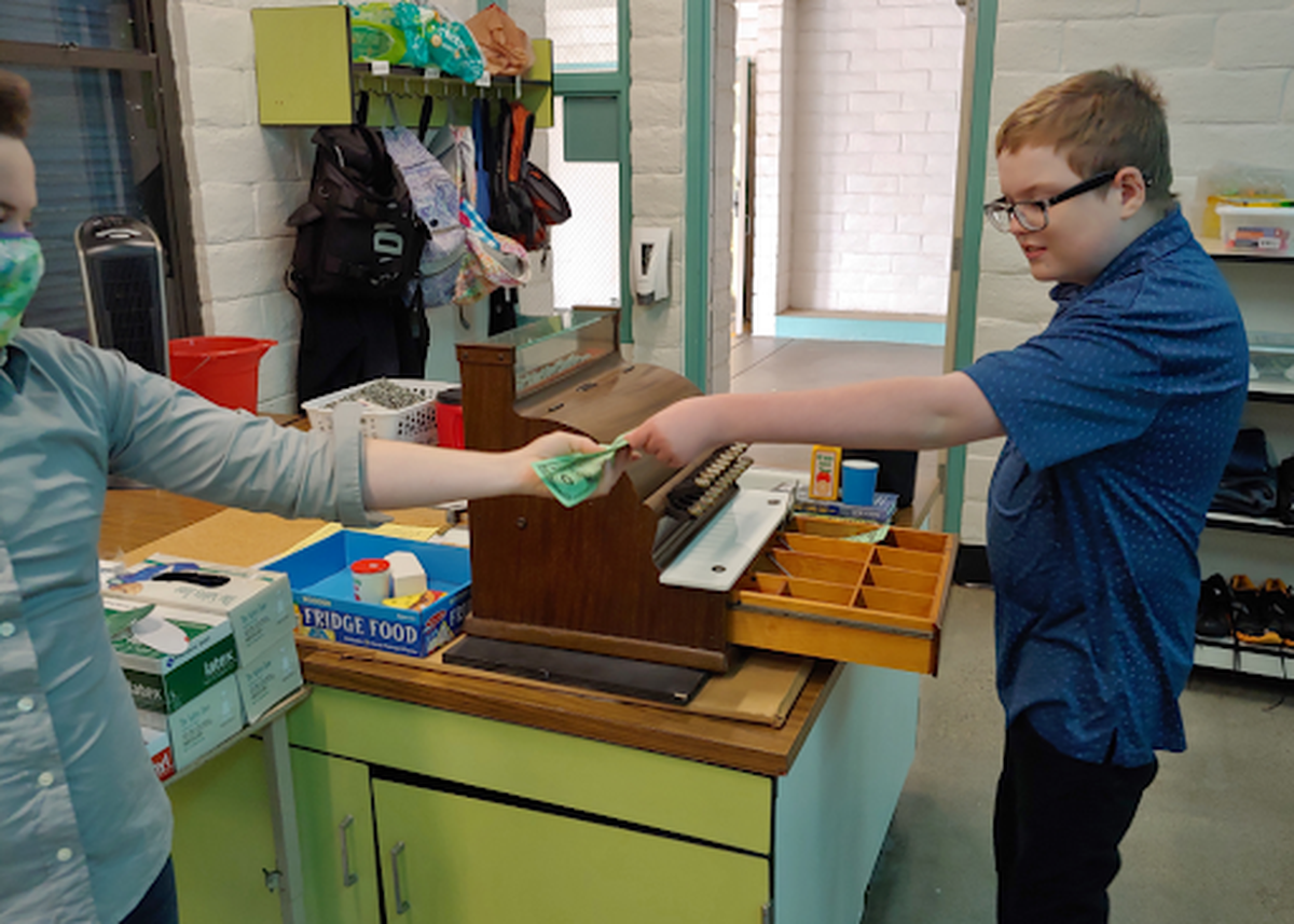 Finnegan Lewis, a Los Osos Middle School student with special needs, working a mock cash register while at school. Tiff Buckman, Lewis’s teacher, said this helps him learn math, life, job and communication skills.