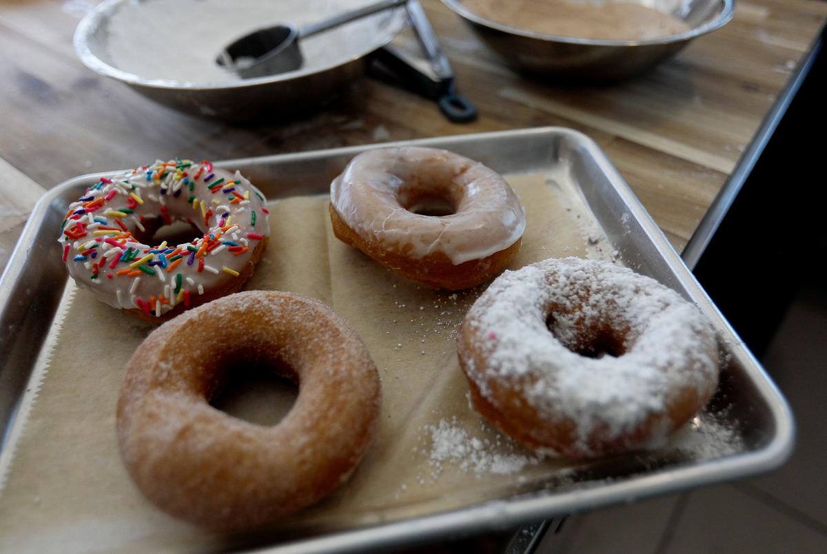 Ben and Jessica Brown acquired the shuttered former fish smokehouse in Cayucos and transformed it into a new, eye-catching doughnut shop, Surf Rats Donuts. A tray of freshly made doughnuts.