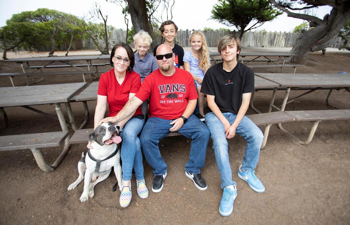 Diana Suhovich and her fiancé Thomas Oxley never thought they’d be facing homelessness with their four children and beloved 15-year-old dog. From left, Diana Suhovich and fiance Thomas Oxley and Aiden Pacheco, 18. On table are Blake Oxley, 10, Anthony Capossele, 13, Annalise Oxley, 7.