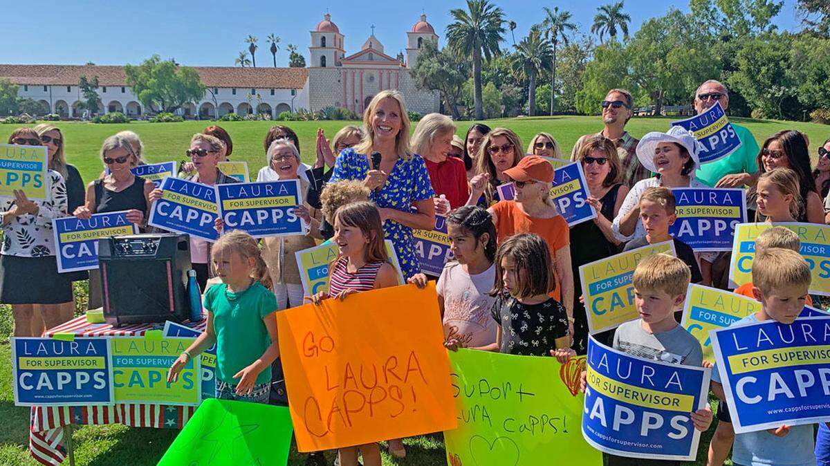 Laura Capps is surrounded by supporters, many of them children, on Tuesday as she announces her candidacy for the First District seat on the Santa Barbara County Board of Supervisors. She is challenging fellow Democrat Das Williams, the incumbent.