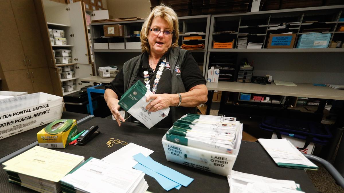 Cindy Osgood organizes ballots Wednesday at the SLO County Clerk-Recorder’s Office. Valid ballots are still arriving by mail.