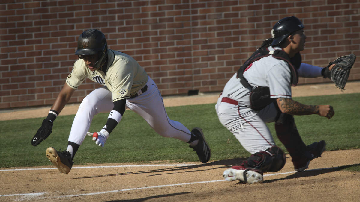 Alejandro Garza dives into home as the throw it late to Mace Wheeler. Cal Poly shut out Santa Clara 7-0 in a baseball game on April 28, 2026.