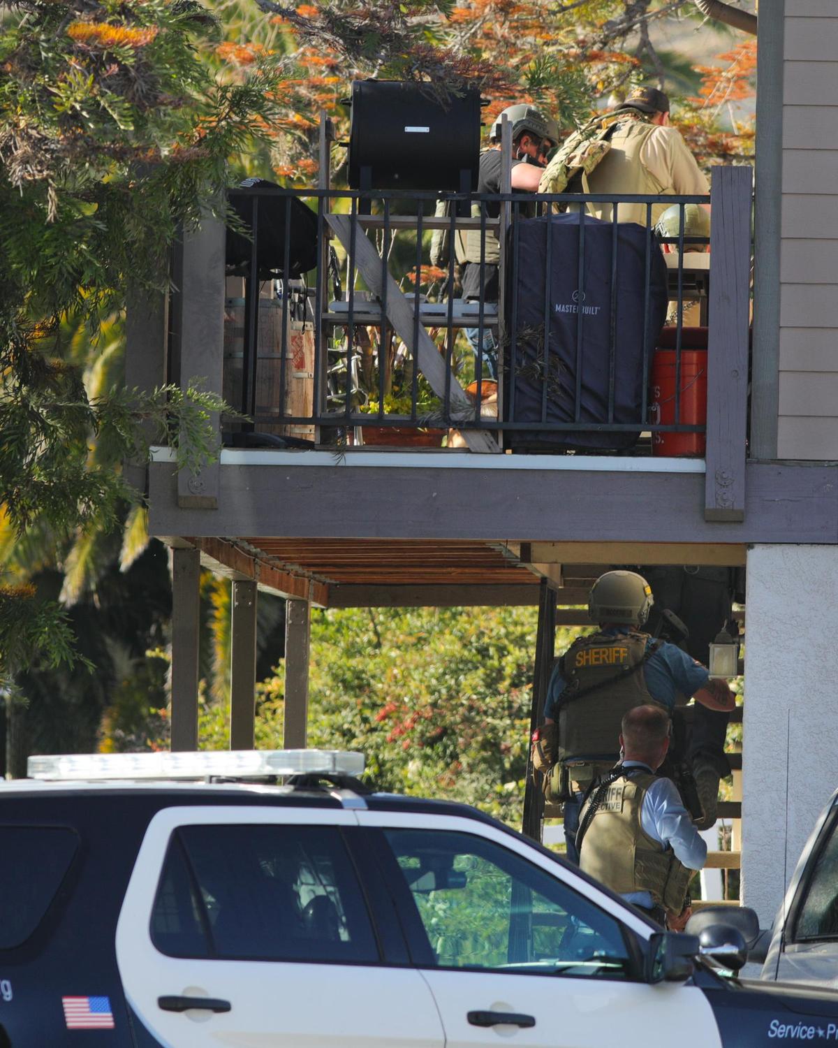 Police and sheriffs search an apartment on Camilla Court where shots were fired. Two police officers and a suspect were shot during a warrant search off of Margarita Avenue. The suspect was confirmed dead, but the condition of the officers was not released initially.