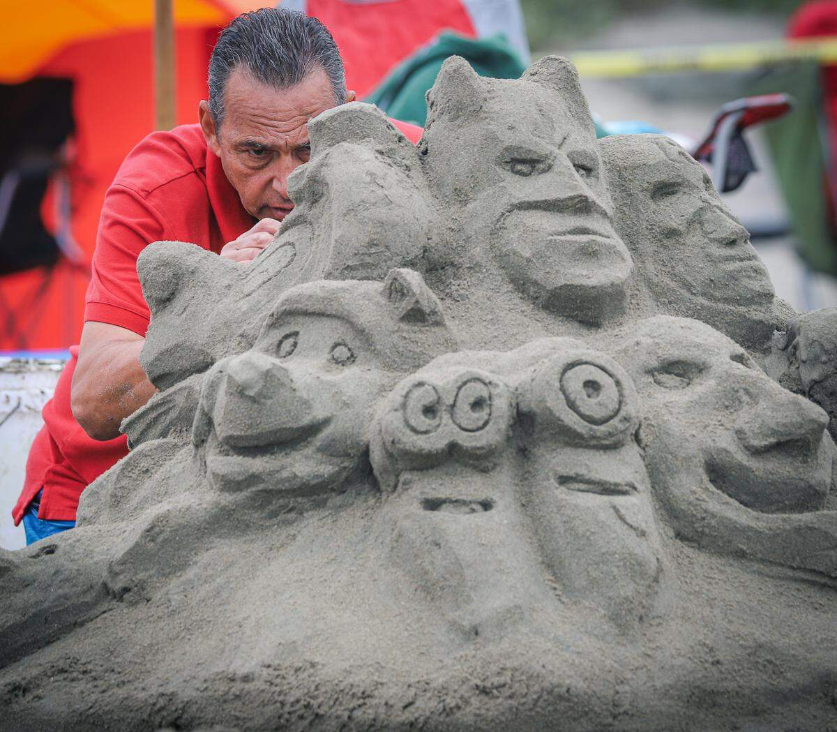An artist works on a sand sculpture in Cayucos on July 4, 2021.