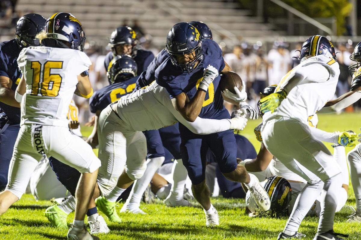 Caleb Clark pushes through the Sunnyside defense in a 62-14 Arroyo Grande win.