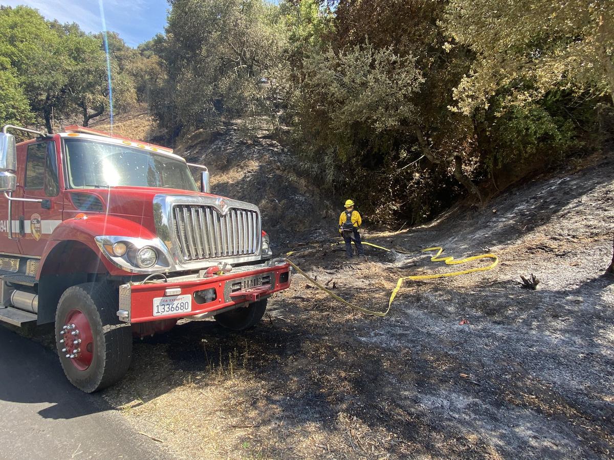 Cal Fire crews on Sunday battle steep terrain and high temperatures while working to contain the 3-2 Fire near Sunset Ridge and Santa Rita roads east of Cayucos in San Luis Obispo County, California.