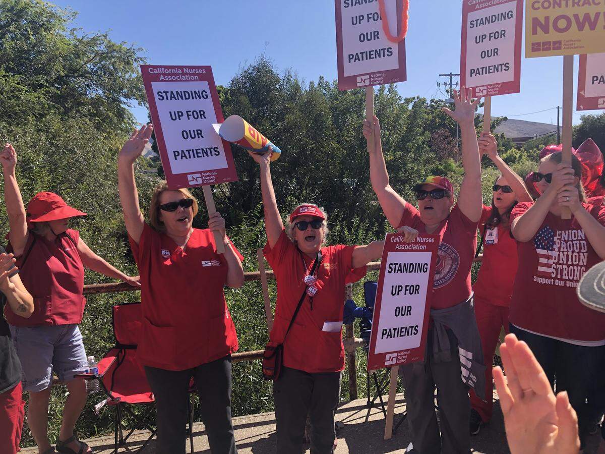 Sherri Stoddard, center, rallies the assembled crowd of nurses and supporters during a strike FRiday in front of Sierra Vista Regional Medical Center.