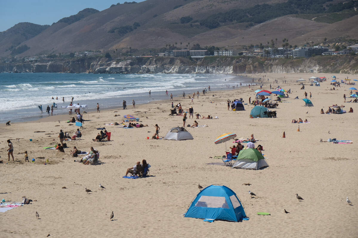 Visitors dot Pismo Beach north of the pier, taking a break from the hot weather in the inland regions of San Luis Obispo County on July 9, 2026.