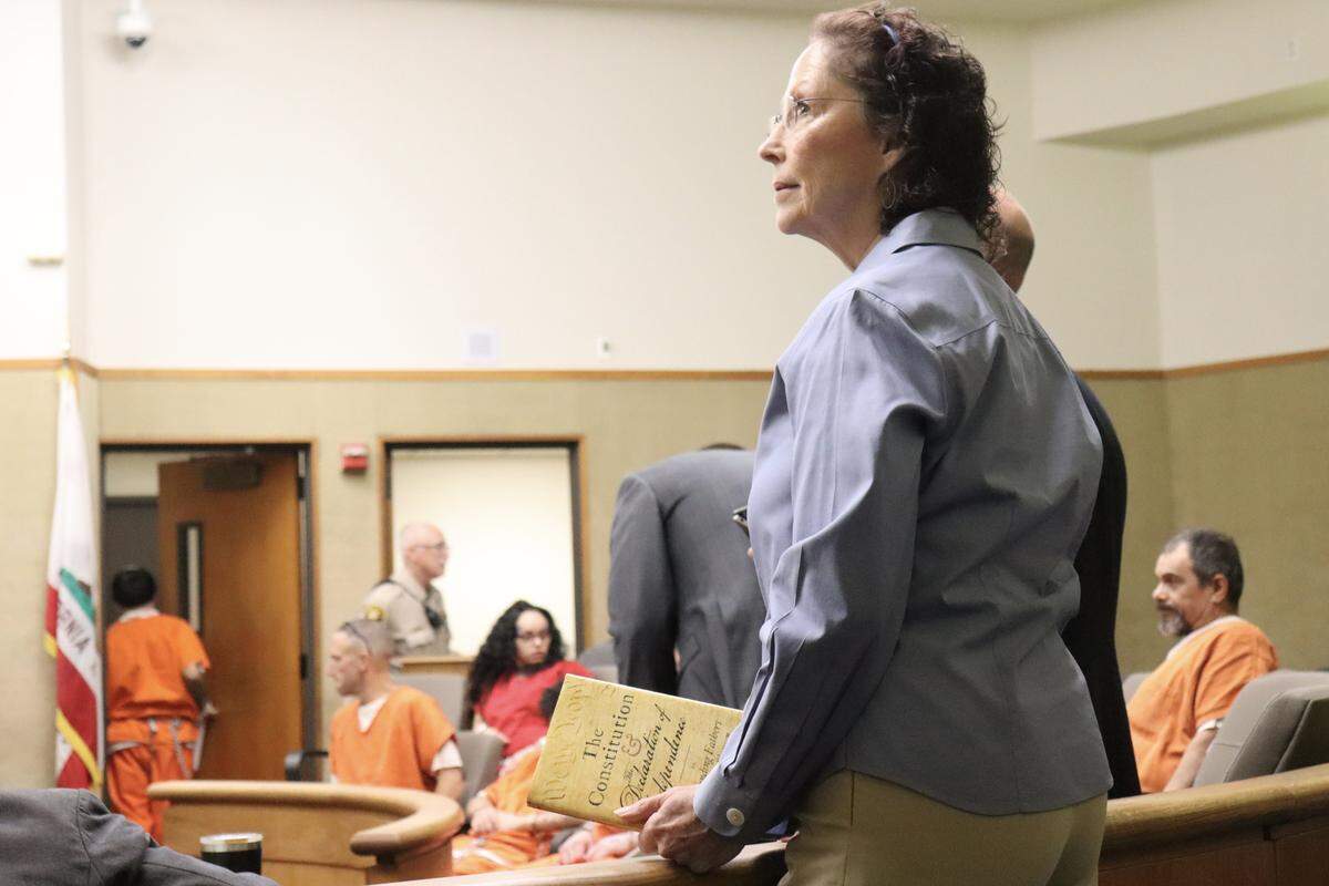 Former two-time Arroyo Grande mayoral candidate Gaea Powell, who has been charged with nine counts of election and voter fraud — including eight felonies — relating to both campaigns, held a copy of the Constitution as she requested to invoke her constitutional right to represent herself in court on Sept. 15, 2025.