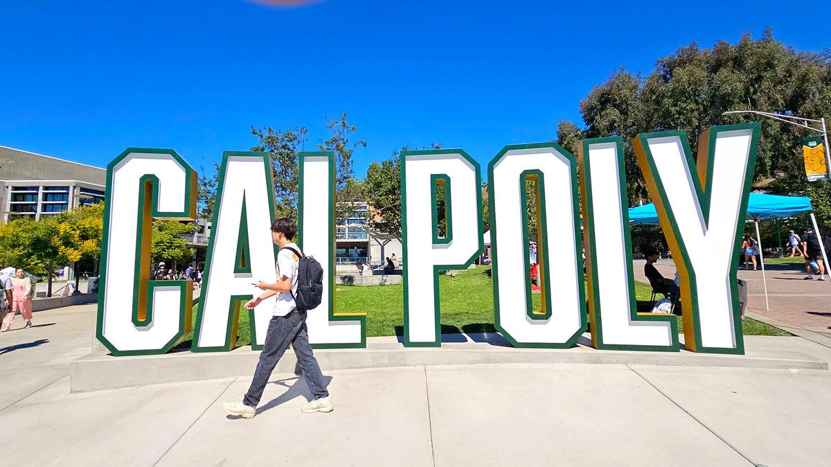 Students walk past the Cal Poly sign in the University Union on Sept. 24, 2024.