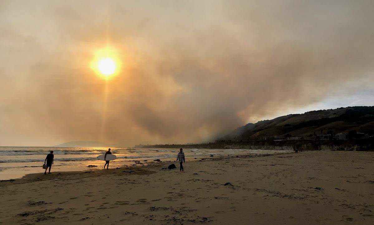 Smoke from the Avila Fire shrouds the sun in a view from Pismo Beach at around 7 p.m. Monday.
